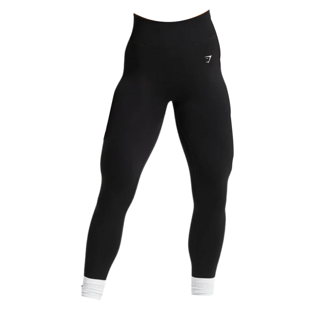 Black high-waisted leggings with a fitted design and ankle cuffs, featuring a small logo on the waistband. Perfect for workouts.