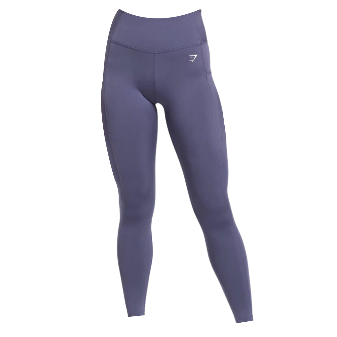Gymshark Leggings featuring a high waistband, subtle front seam detailing, side pockets, and a white logo on the left hip.