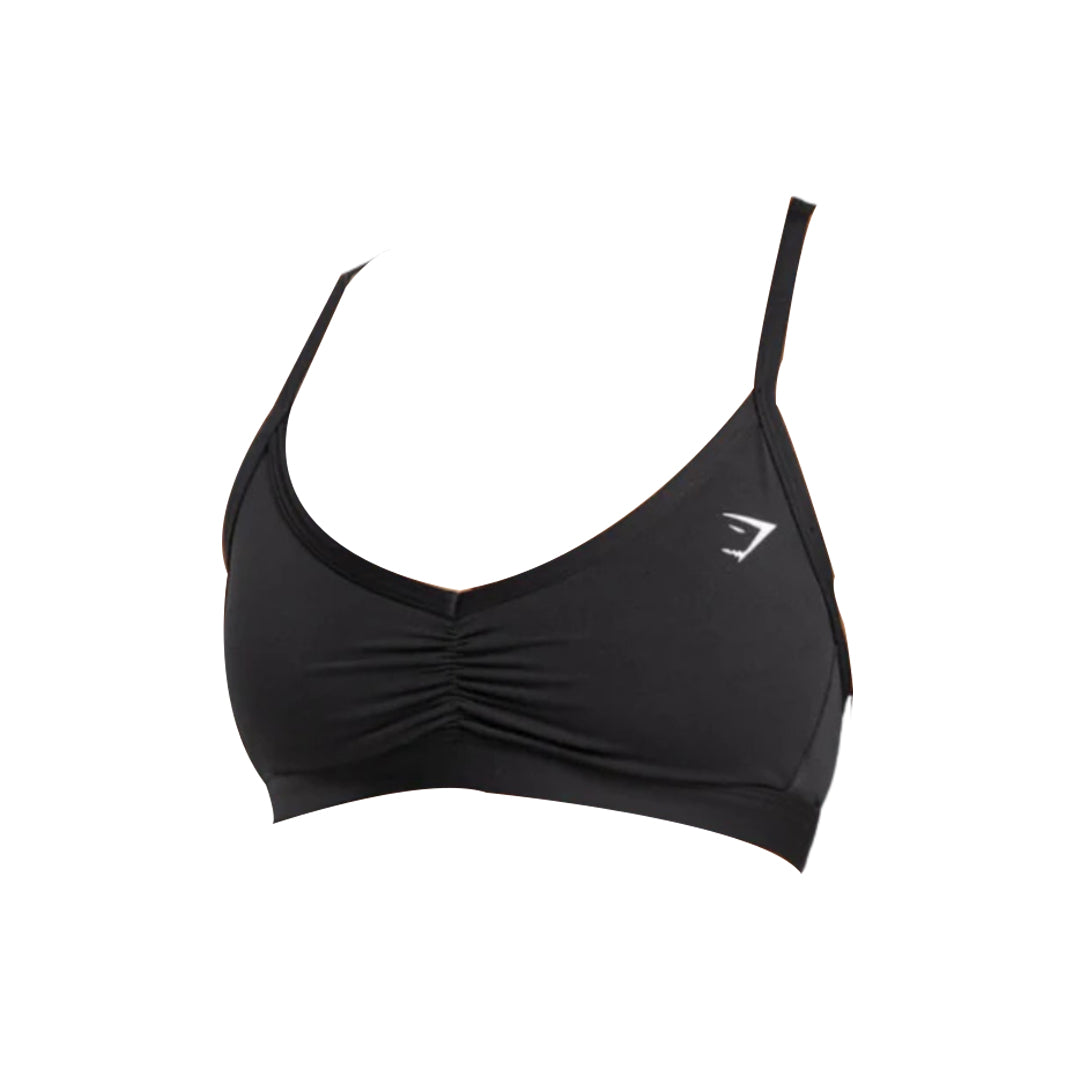Black sports bra with a gathered front design and thin adjustable straps, featuring a small logo on the side.