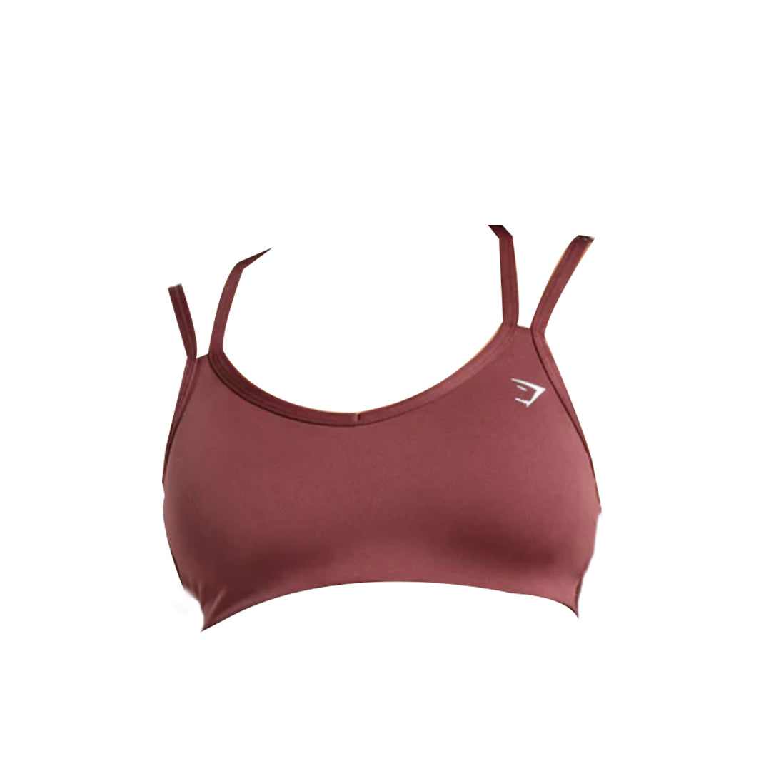 Maroon sports bra with adjustable straps and a logo, designed for comfort and support during workouts.