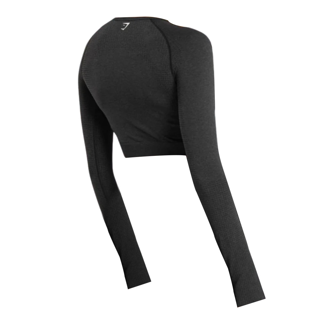 Back view of a black Vital Seamless long-sleeve crop top featuring a textured design and a small logo on the neckline.