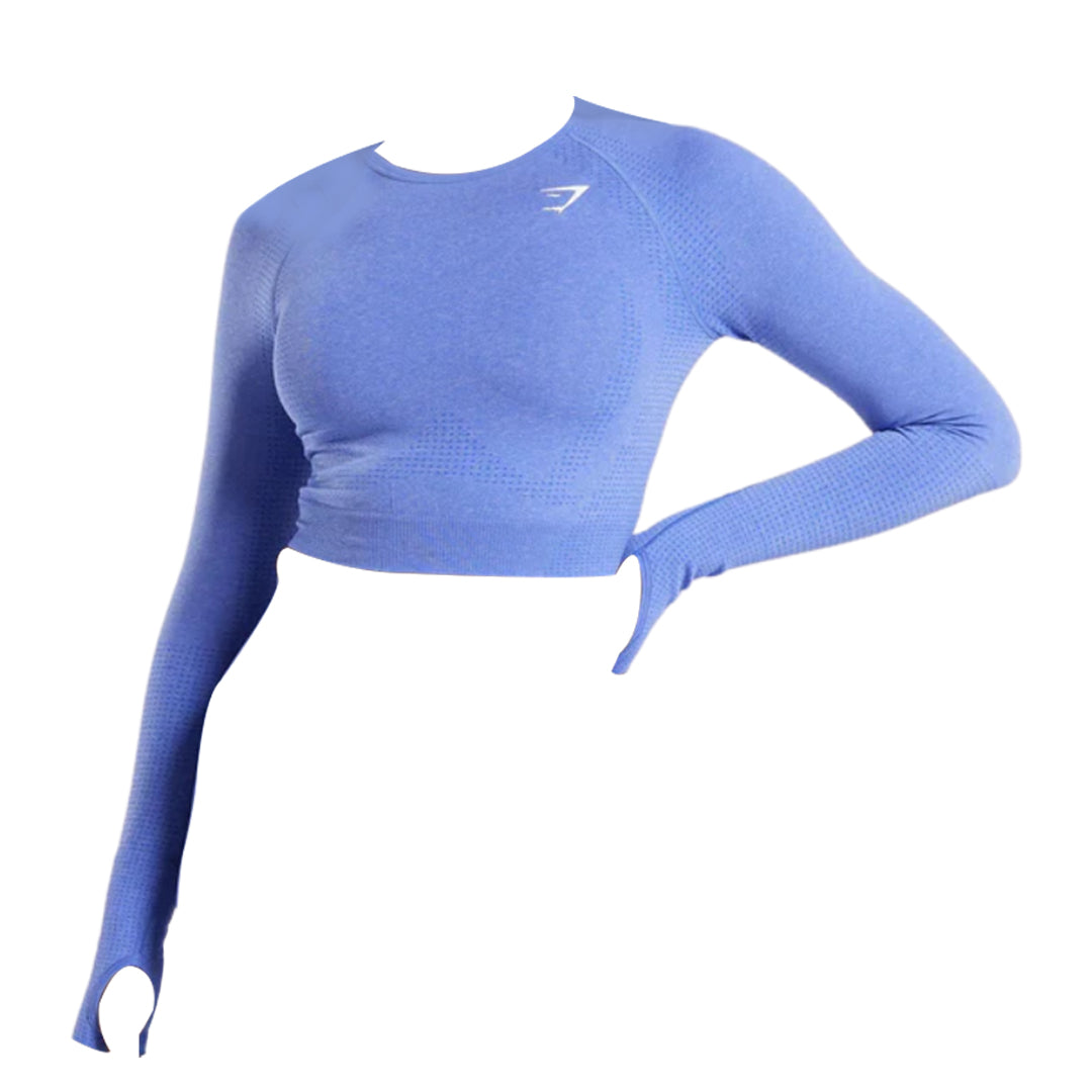 Women's long-sleeve crop top in soft blue fabric, featuring a fitted design and thumbholes for added comfort during workouts.