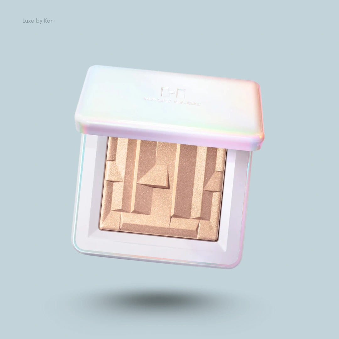 Haus Labs gel-powder highlighter with fermented arnica in a square, iridescent compact with a gold, geometric product pan.