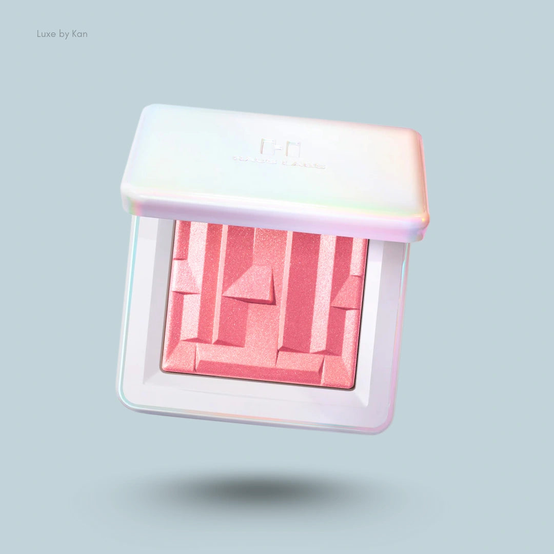 Haus Labs gel-powder highlighter with fermented arnica in a white compact, showcasing the product's textured surface.