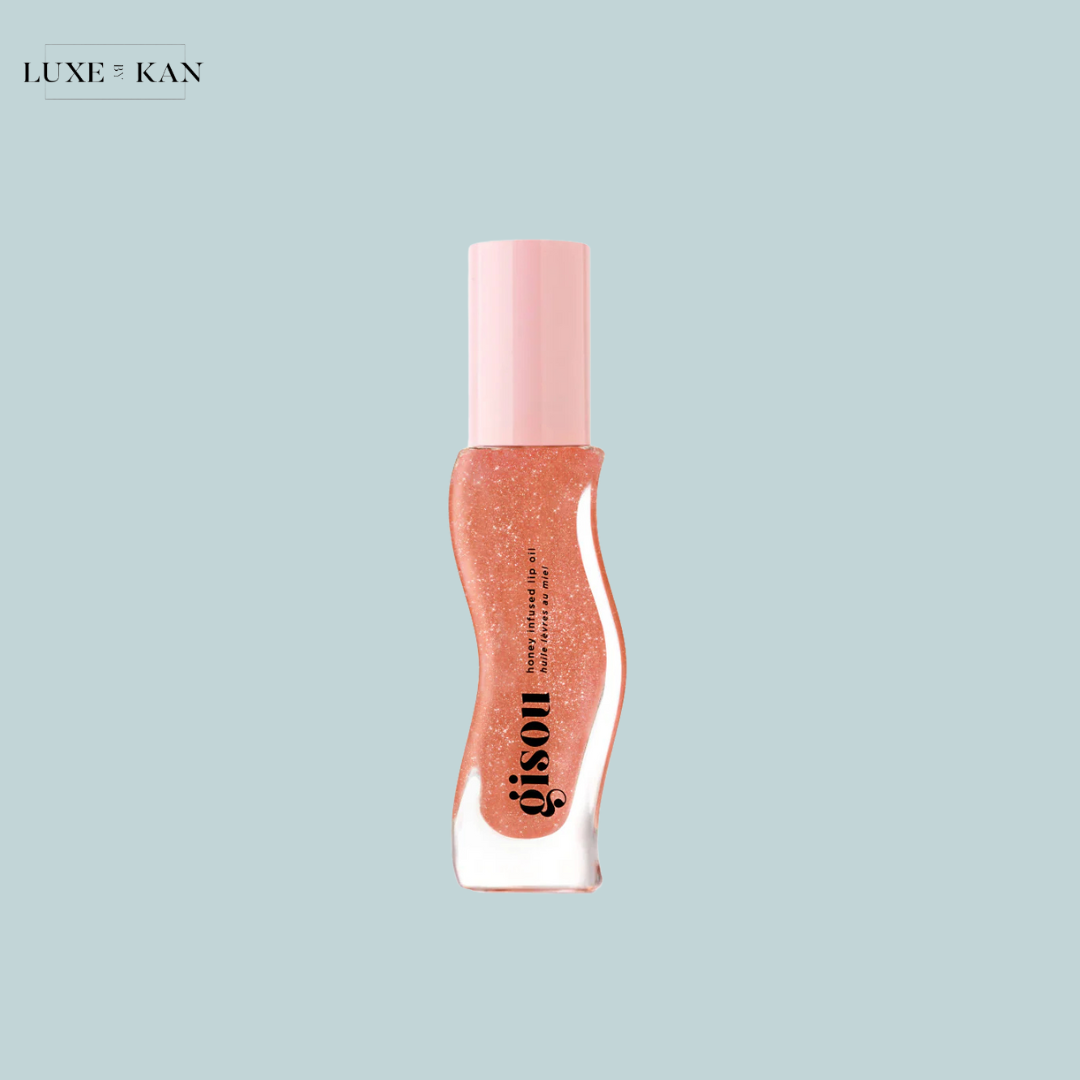 Gisou Honey Infused Lip Oil sparkling pink lip gloss in a wavy clear tube with a pink cap.