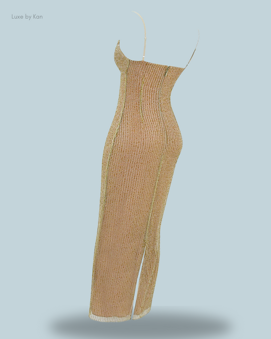 A sleek, gold-toned House of CB Alondra Café au Lait beaded knit maxi dress with spaghetti straps, featuring a figure-hugging silhouette and a thigh-high slit.