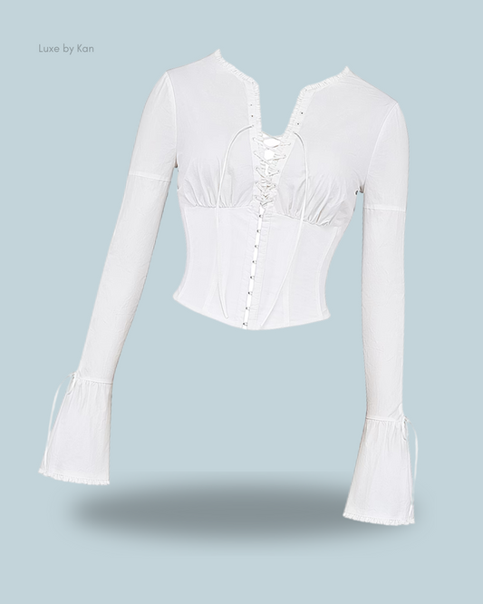 House of CB White Anissa long-sleeve top featuring a lace-up front, button detailing, flared sleeves, and a fitted silhouette for a stylish and elegant look.