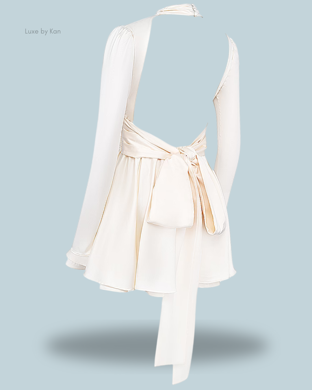 Creamy-white aryana ivory mini dress with a deep back, long sleeves, and a tied waist, showcasing elegance and a flowing silhouette.
