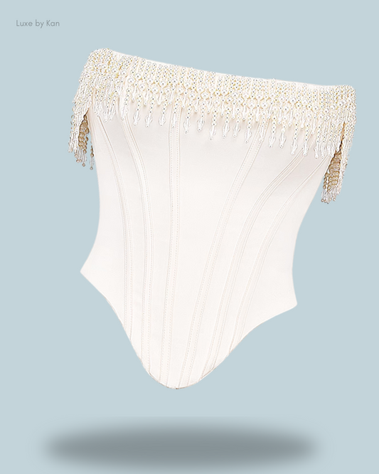 House of CB Aubrie vintage cream embellished satin corset featuring intricate pearl fringe detailing, structured lines, and a chic, sculpted silhouette.