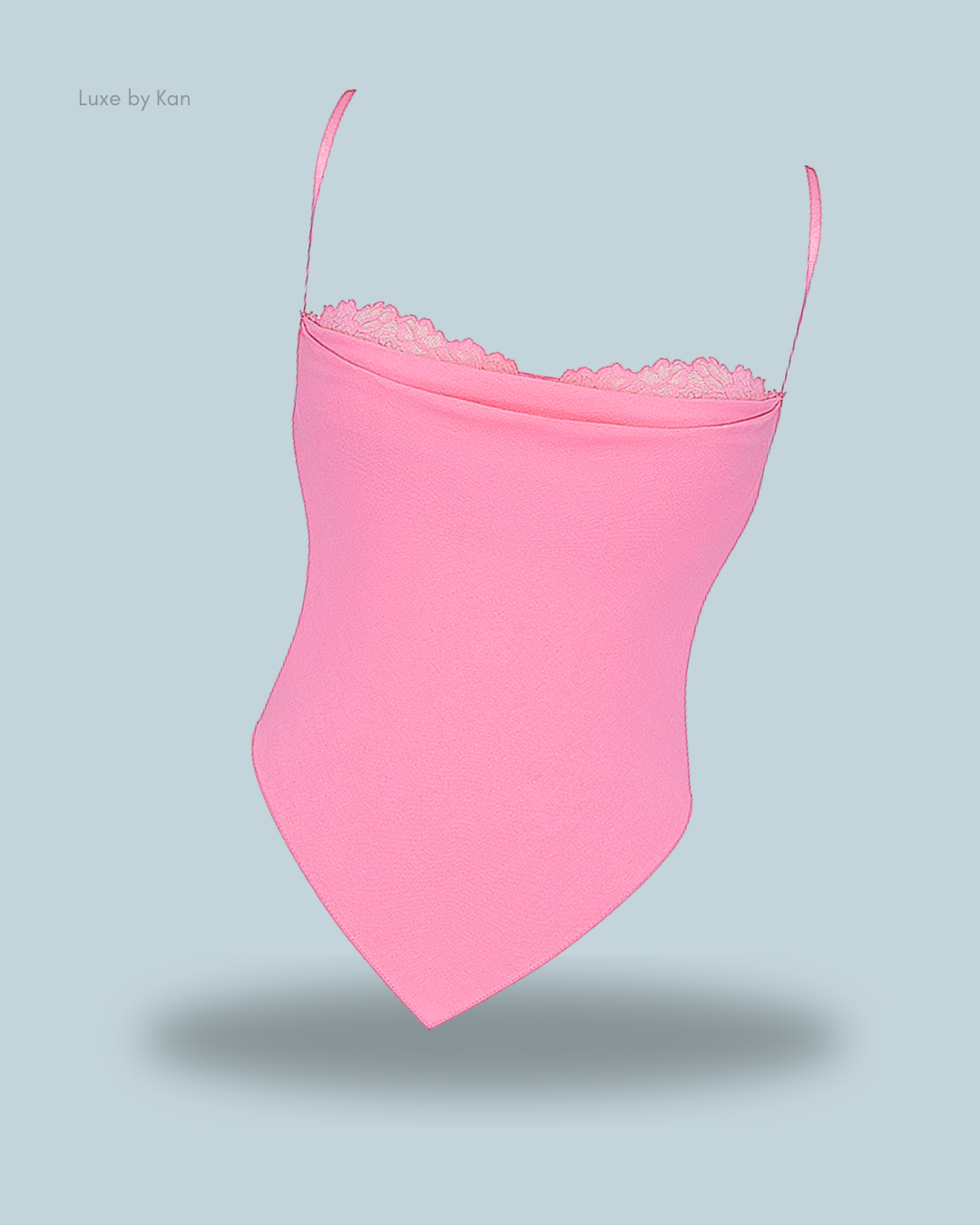 Light pink House of CB Aurelia French Pink Hanky Hem Top, featuring delicate lace trim and adjustable straps for a feminine, tailored fit.