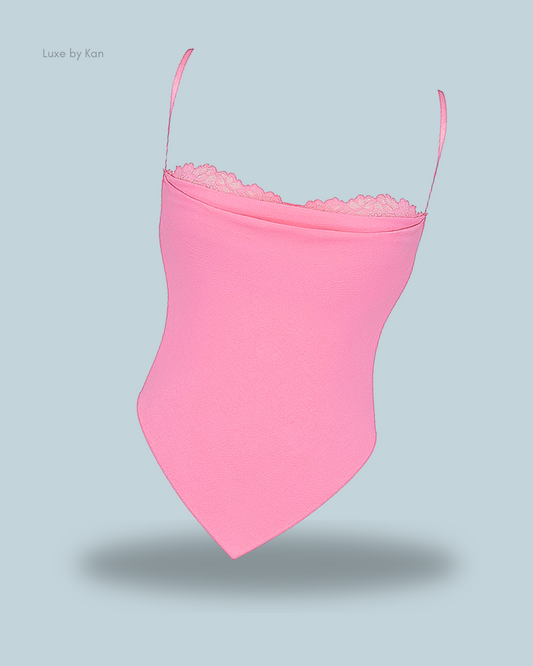Light pink House of CB Aurelia French Pink Hanky Hem Top, featuring delicate lace trim and adjustable straps for a feminine, tailored fit.