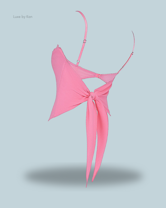 A stylish pink House of CB Aurelia French Pink Hanky Hem Top featuring thin straps and a chic knotted back design for a feminine, elegant look.
