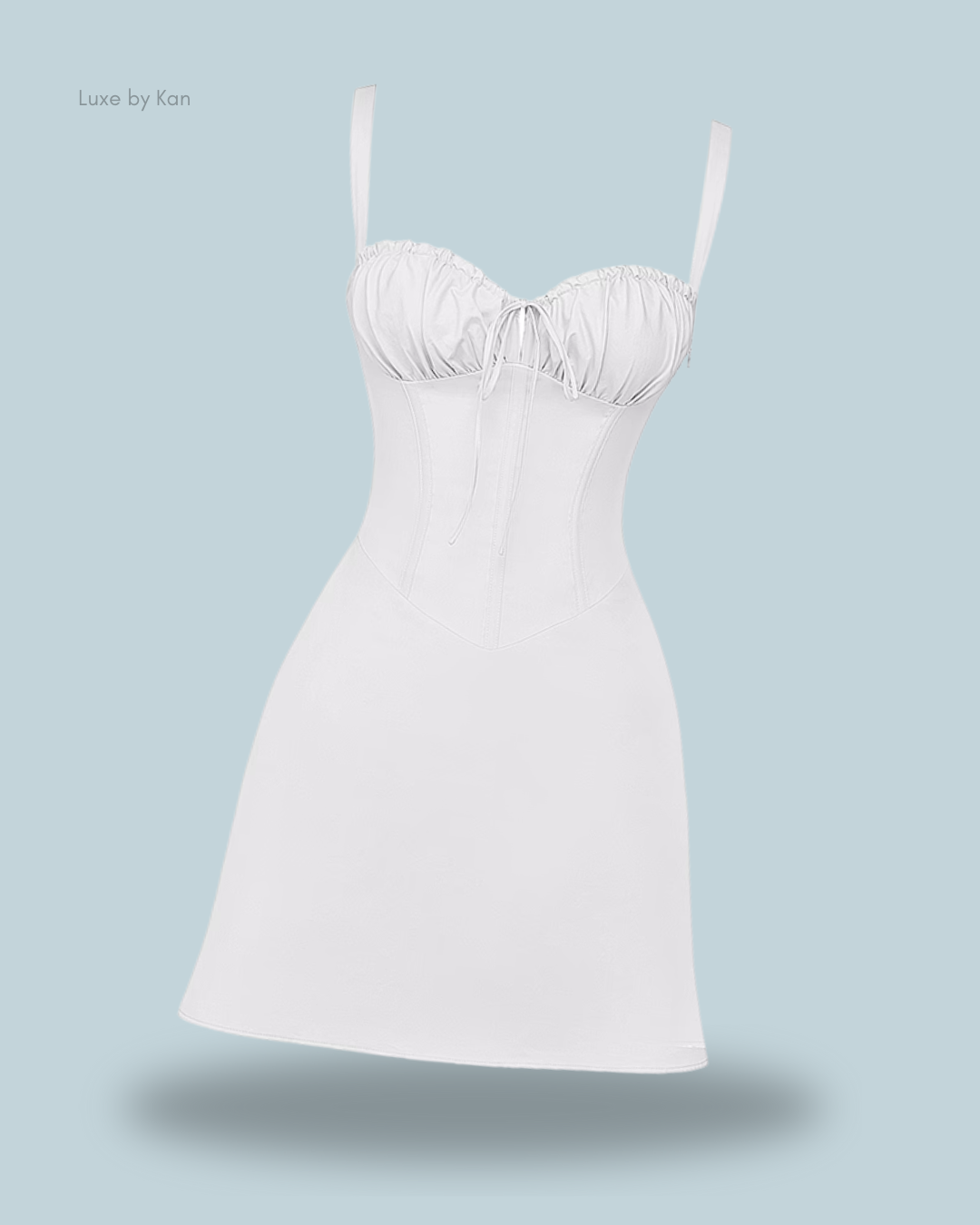 A white Carlotta corset mini dress featuring a fitted bodice, adjustable straps, a sweetheart neckline, and a structured seamed design.