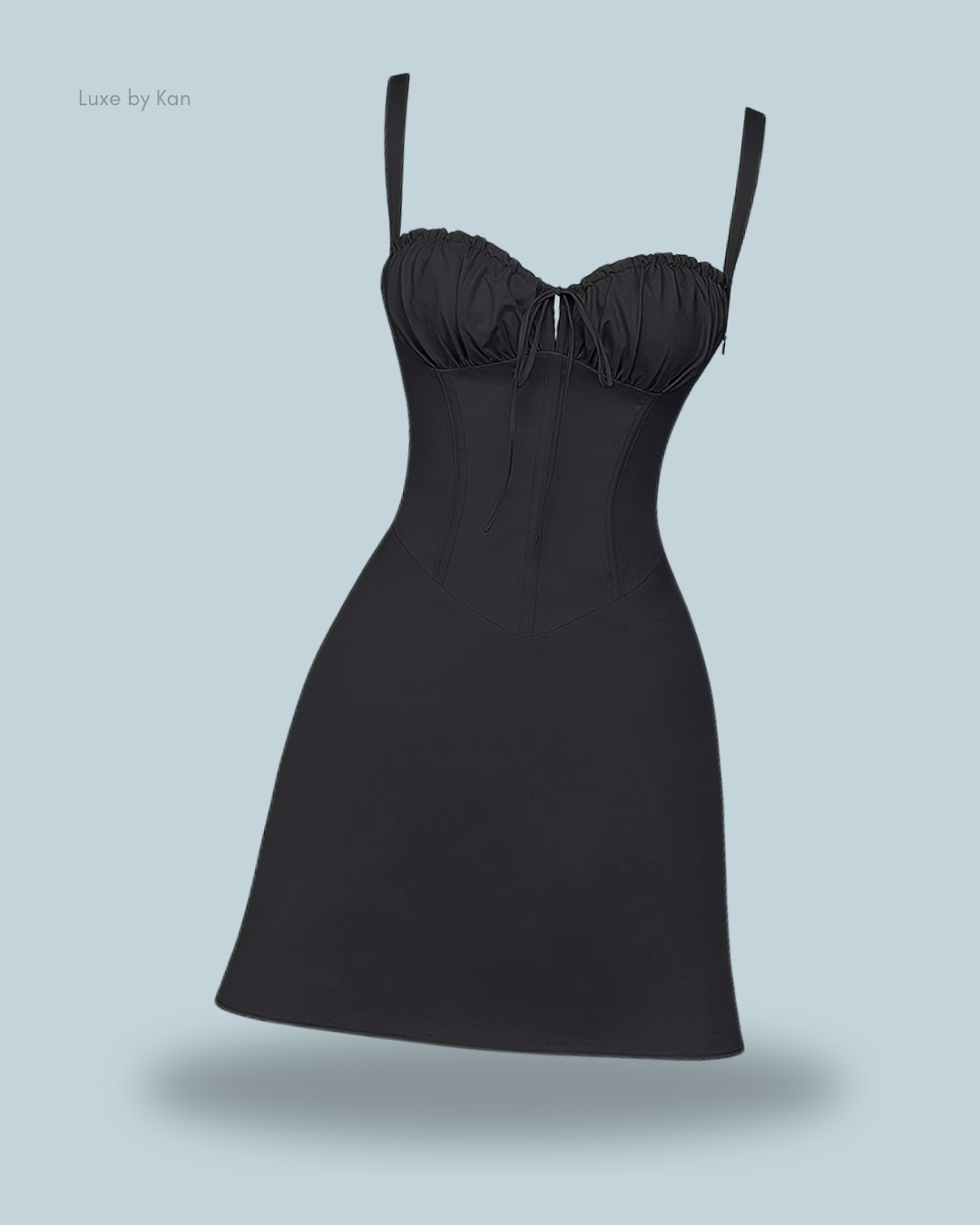 Black fitted dress featuring a ruched bodice, adjustable straps, and a flared skirt.