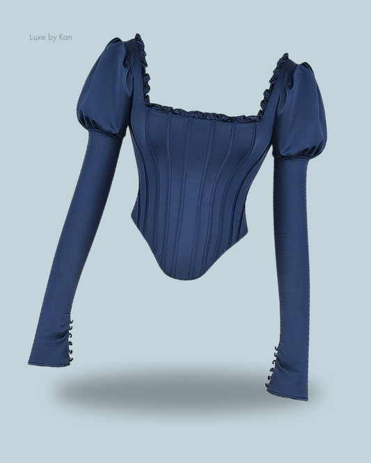House of CB Dana navy puff-sleeve corset featuring voluminous sleeves, a ruffled neckline, structured seams, and decorative buttons on the cuffs for a romantic, tailored finish.