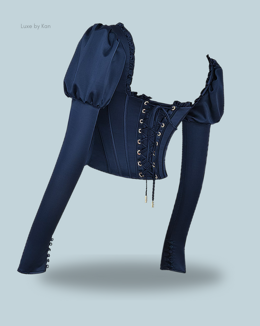 House of CB Dana navy puff-sleeve corset top featuring voluminous sleeves, a lace-up front, and elegant detailing for a modern, chic silhouette.