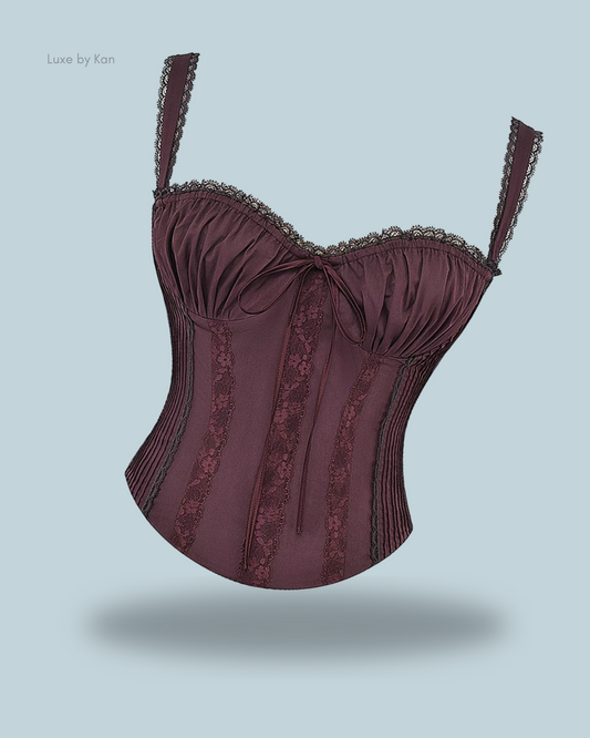 House of CB Gini lace-back corset featuring delicate lace trim, adjustable straps, intricate pleating, and elegant ribbon detailing.