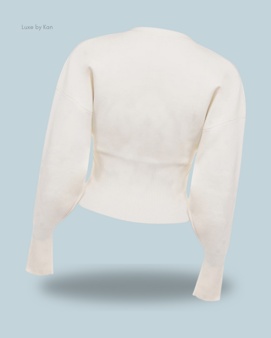 Back view of a stylish noor off white knitted cardigan with long sleeves and a ribbed hem.