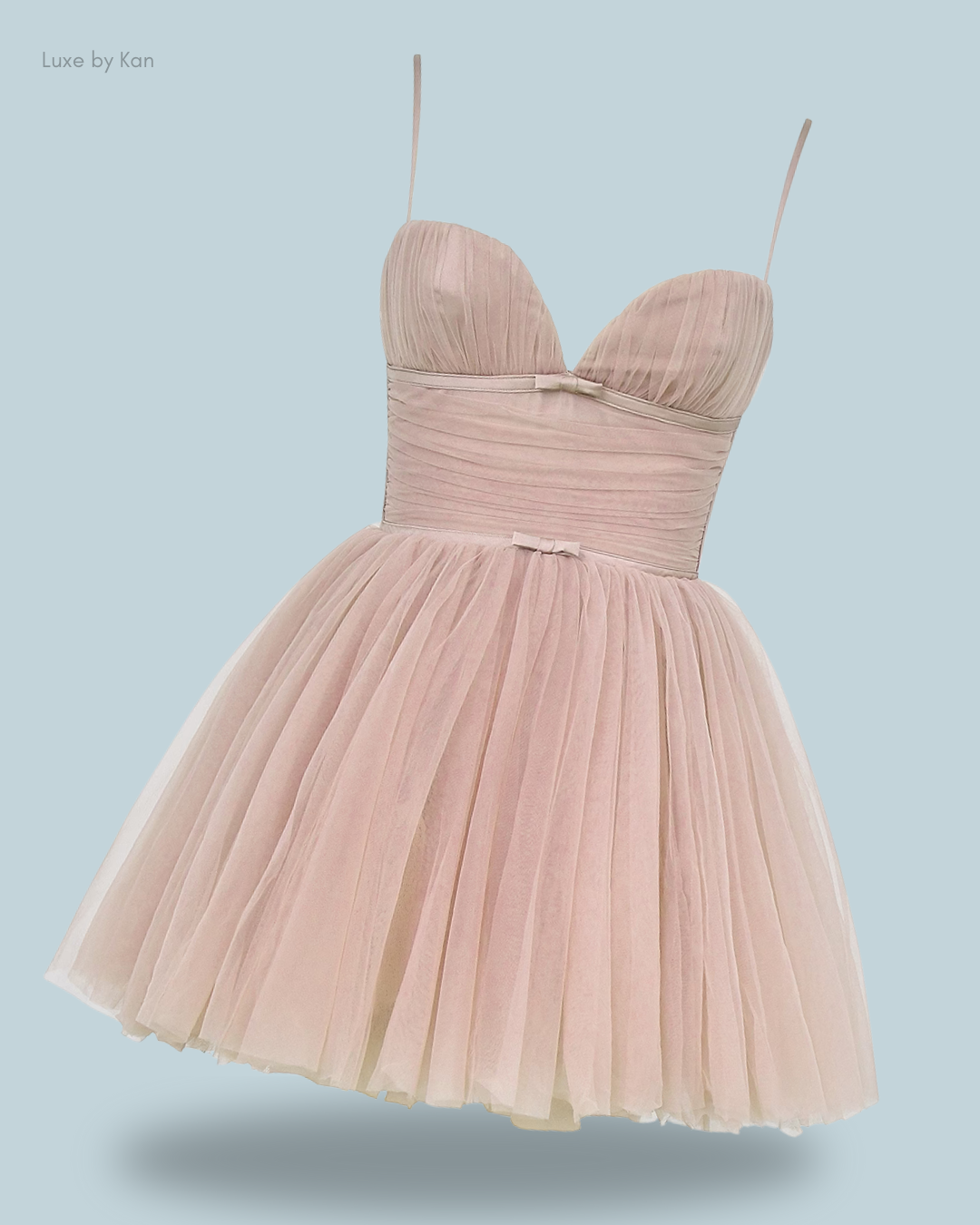 A delicate, pale pink dress with a sweetheart neckline and a flared tulle skirt.