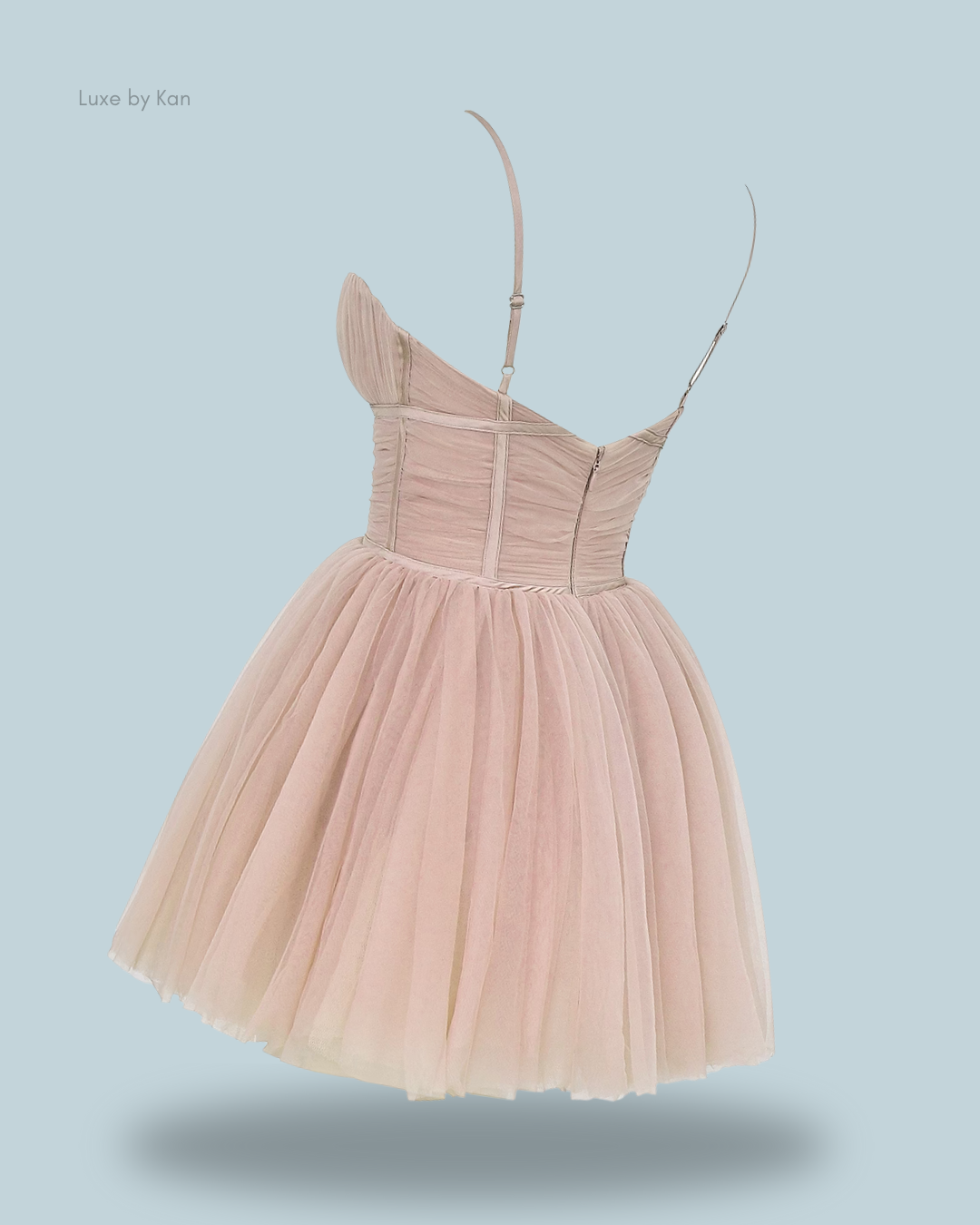 A stylish pastel pink dress with a one-shoulder design and a flared tulle skirt.