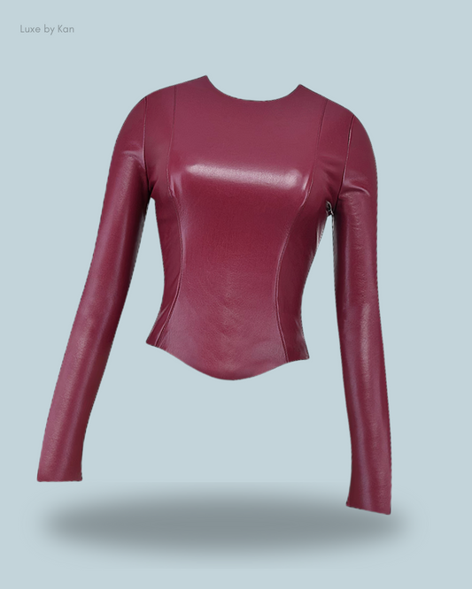 Stylish maroon House of CB wine-toned vegan leather top featuring long sleeves, a round neckline, and a sleek, fitted silhouette.