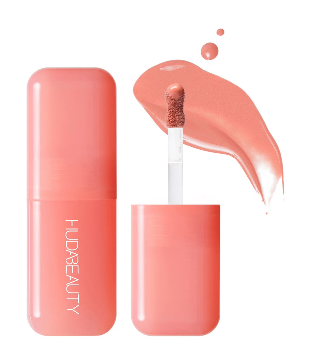 A tube of Huda Beauty blush filter product in peach shade, with an applicator and a swatch of the color beside it.