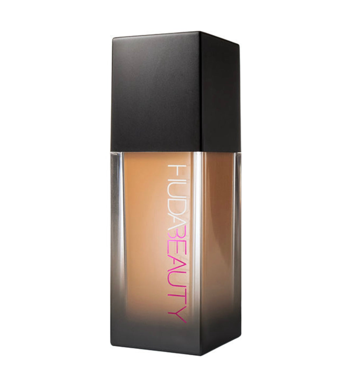 A sleek glass bottle of Huda Beauty fauxfilter foundation with a matte black cap and a gradient gold to clear design.
