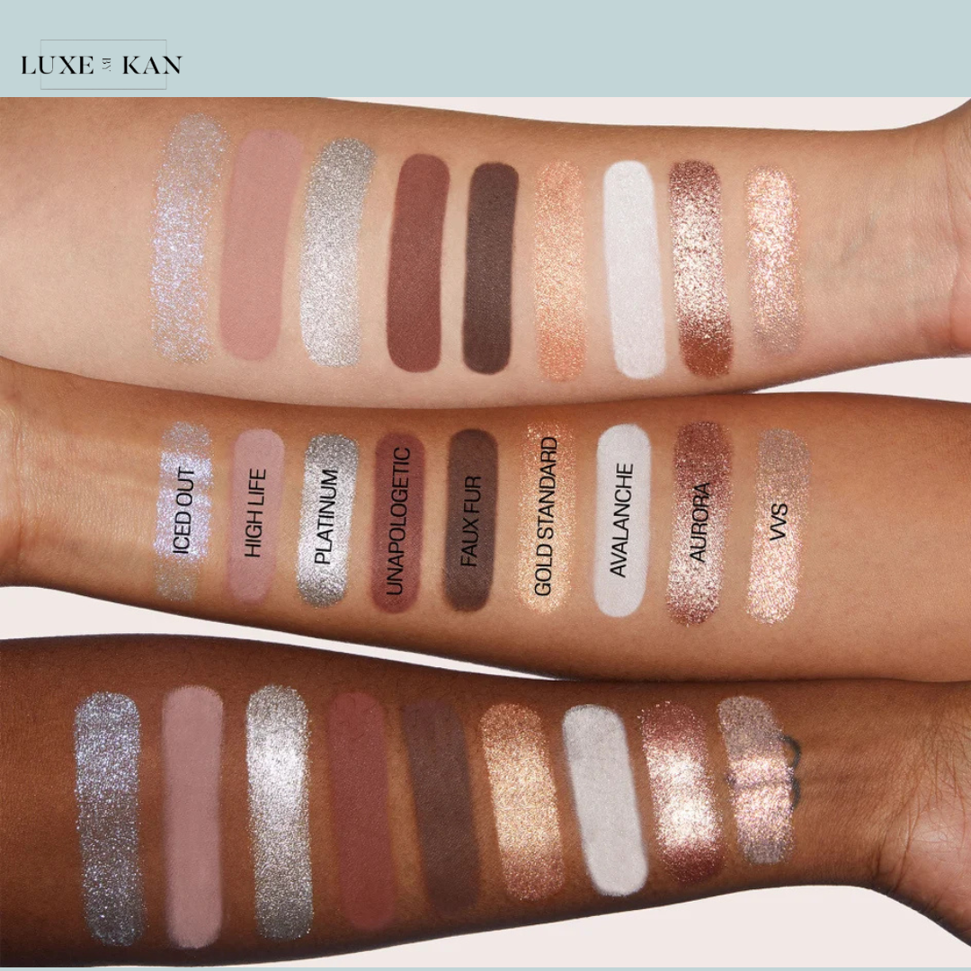 Swatches of various makeup shades on arms, featuring shimmers and matte finishes, labeled with names like "Iced Out" and "Avalanche."
