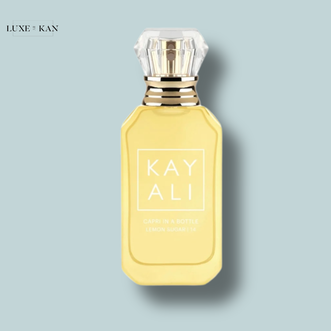 A yellow perfume bottle labeled "Kayali Capri in a Bottle Lemon Sugar 14" with a crystal-like cap.