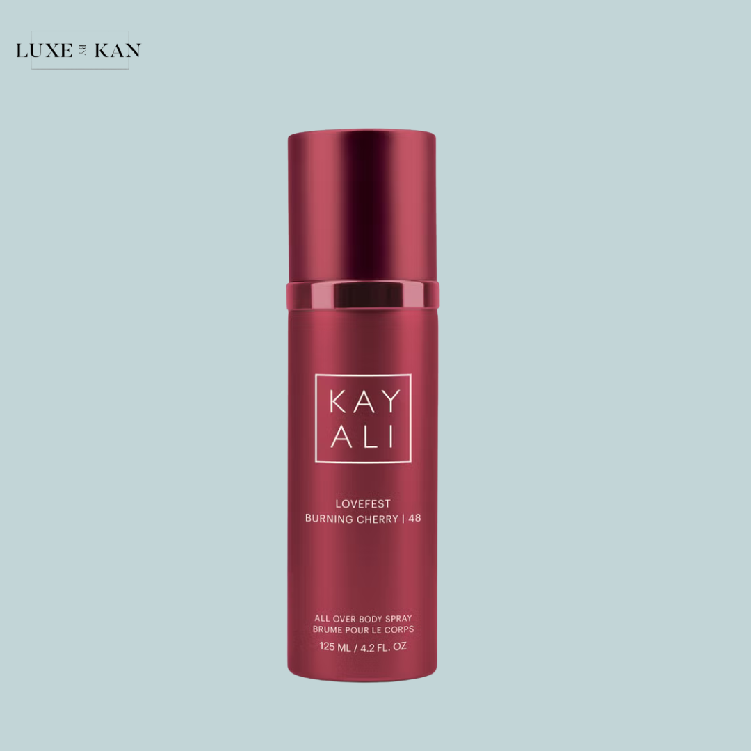 A vibrant cherry-red body spray bottle labeled "KAYALI LOVEFEST BURNING CHERRY 48".