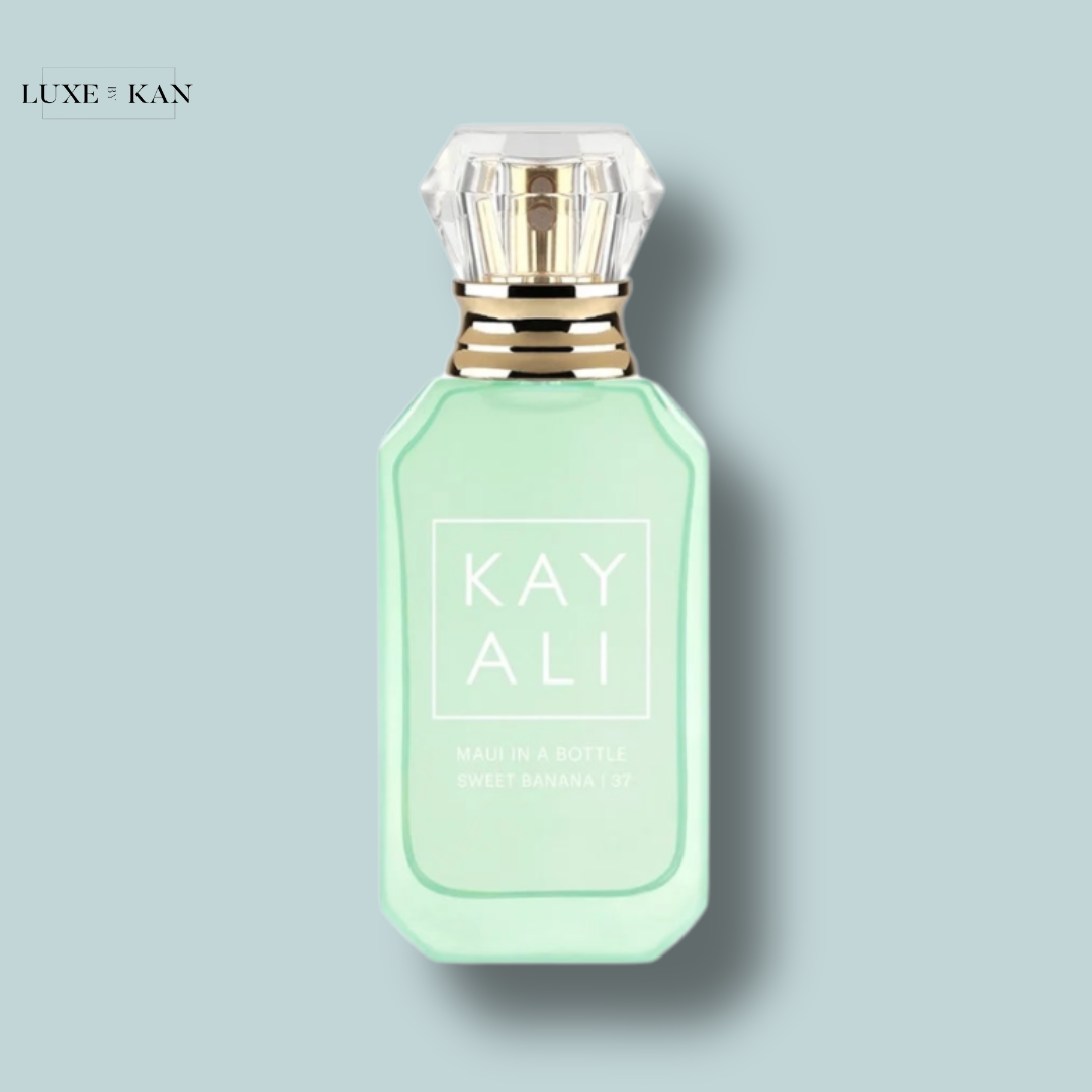 A mint-green perfume bottle with a diamond-shaped cap, labeled "KAYALI MAUI IN A BOTTLE SWEET BANANA."