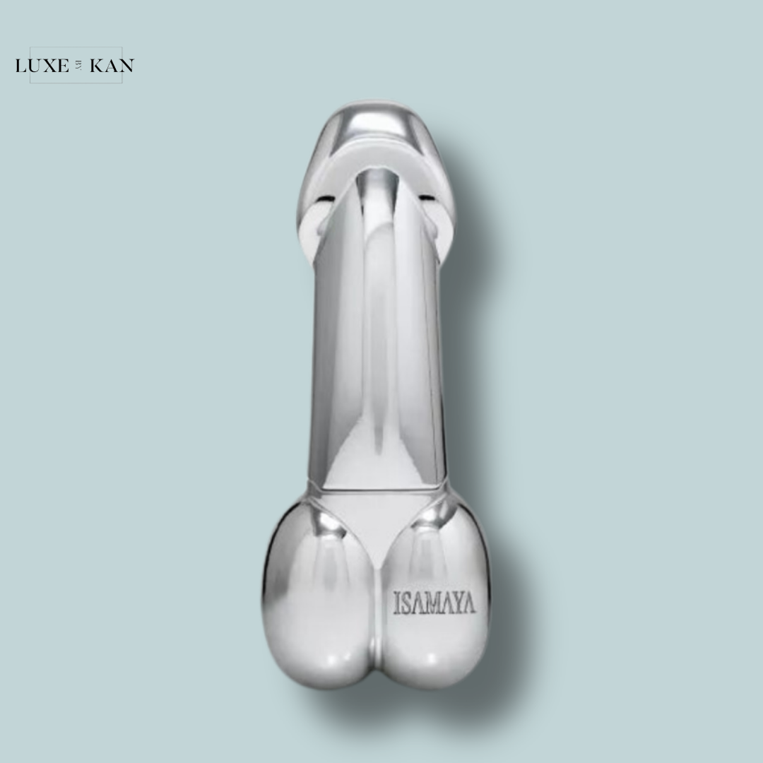 A metallic novelty item shaped like a male anatomical figure, featuring smooth surfaces and the engraving "ISAMAYA".