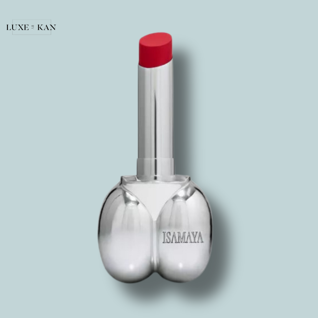 A playful lipstick tube shaped like a pair of lips, topped with a vibrant red bullet, set against a light blue background.