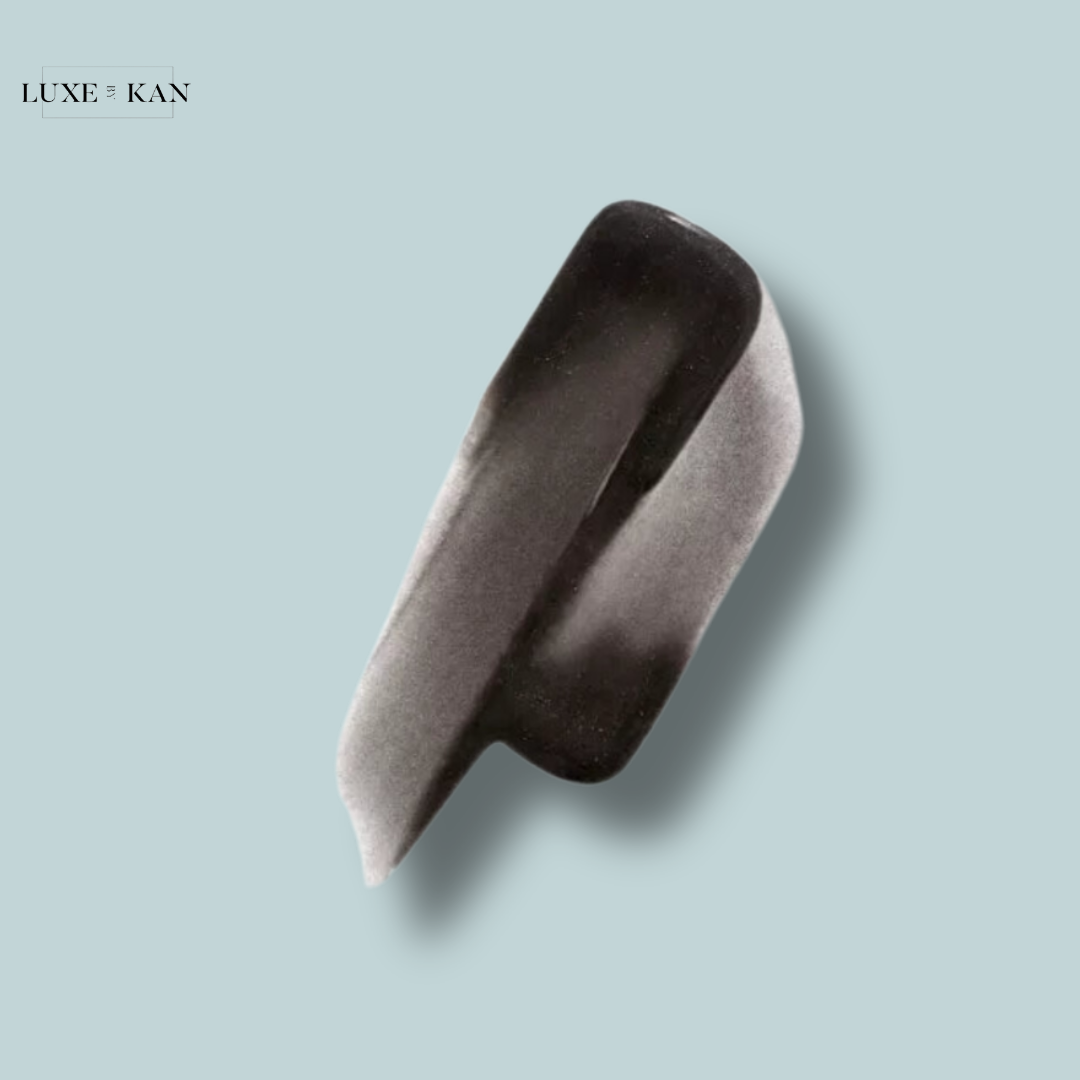 A sleek, modern black and white cosmetics applicator on a light blue background, featuring the Luxe & Kan logo in the corner.