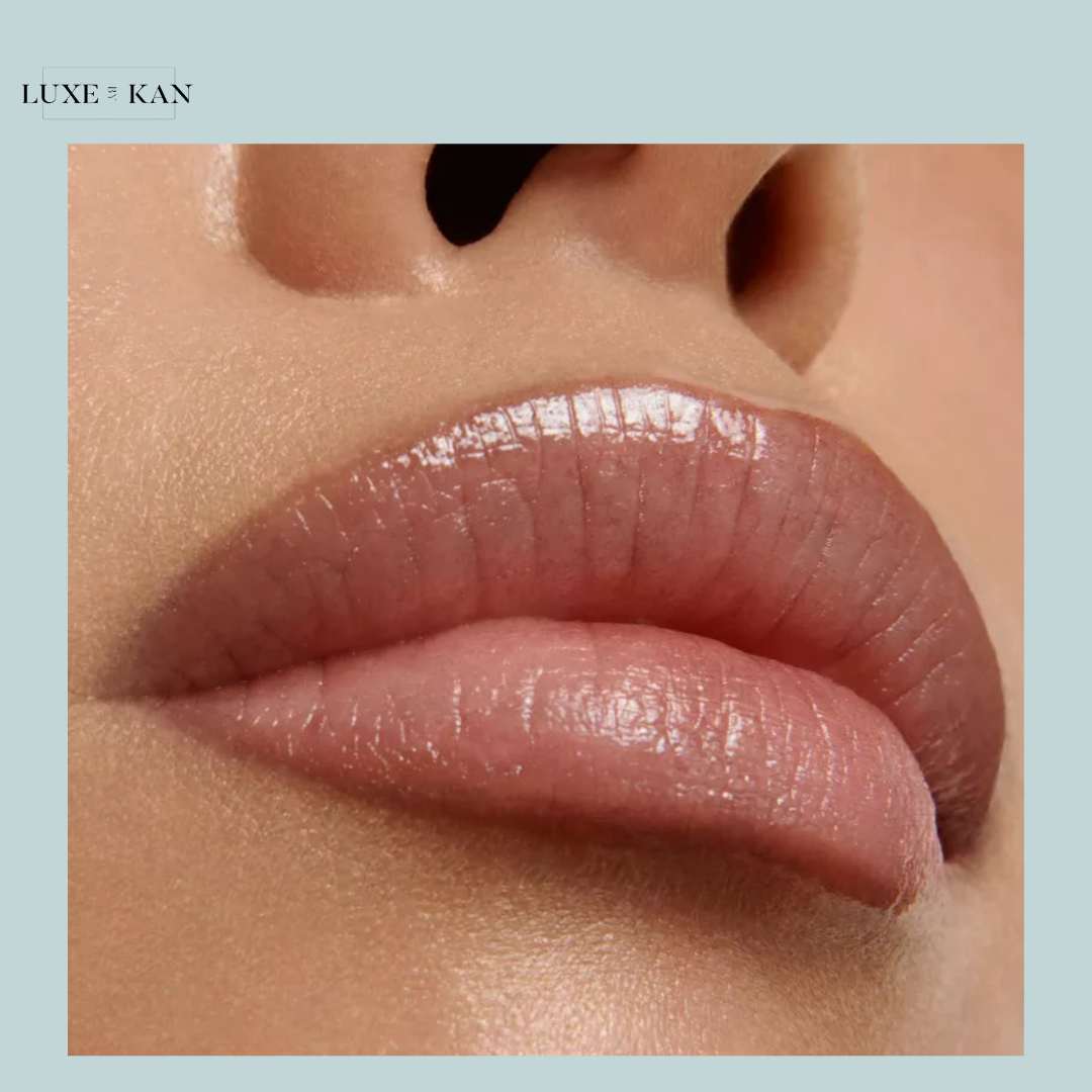 Close-up of glossy, natural lips with a hint of pink, showcasing smooth texture and hydration.