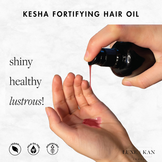 A hand holds a bottle pouring Kesha fortifying hair oil into the palm, with text highlighting shine, health, and luster. Vegan and palm oil-free icons are present.