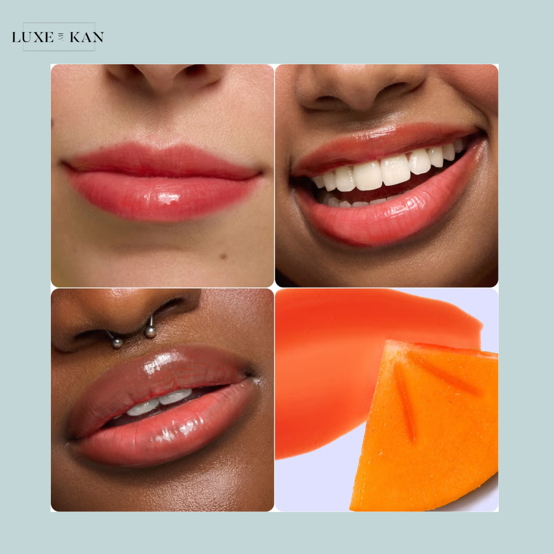 Close-up of glossy lips in a soft coral color, accompanied by vibrant orange fruit slices and a swatch of orange lip product.