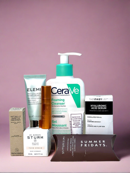 A collection of skincare products on a pink background, featuring brands like CeraVe, Elemis, The Inkey List, and Dr. Barbara Sturm.