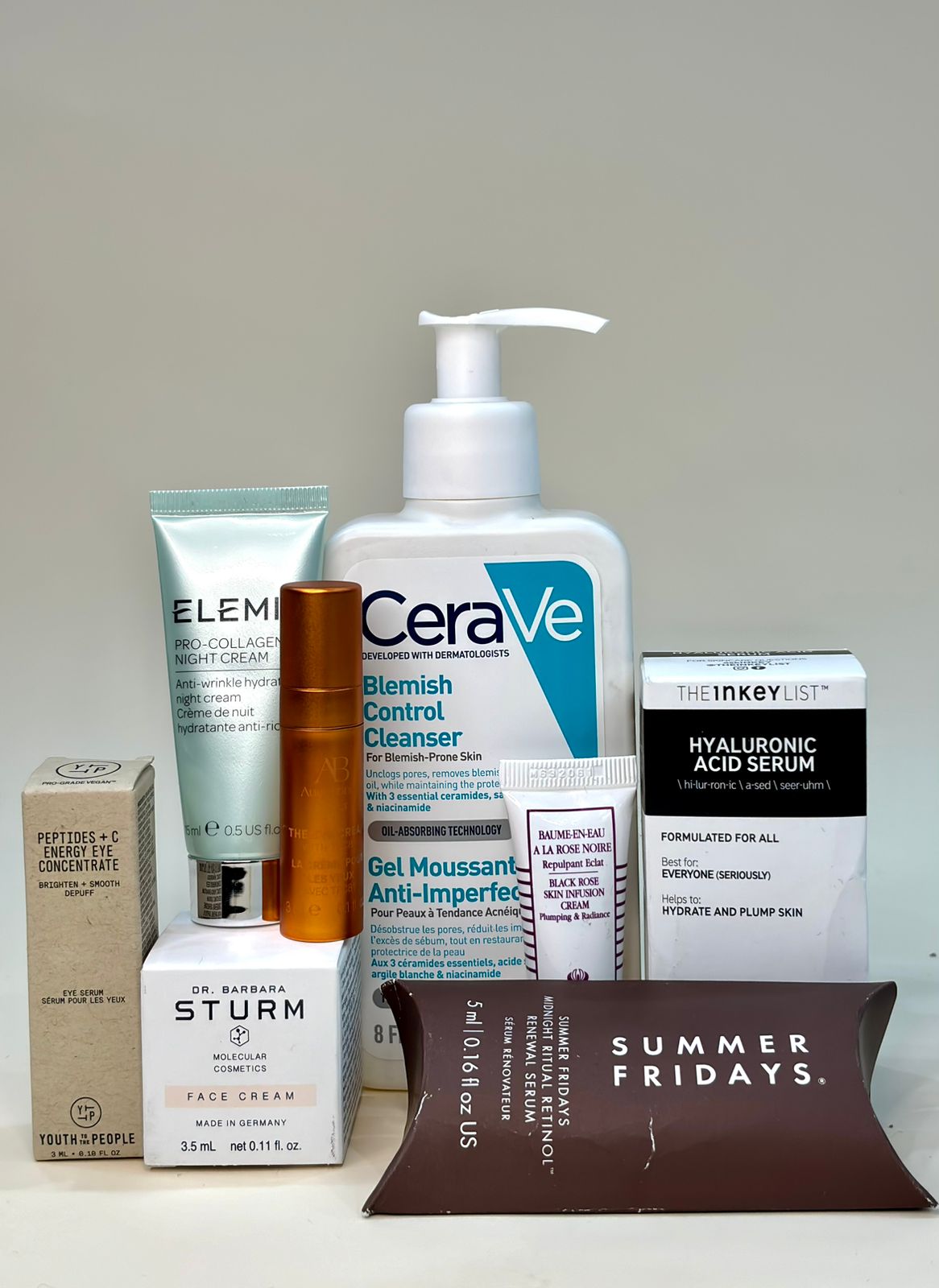 A collection of skincare products including cleansers, serums, and creams from brands like CeraVe, Elemis, and Summer Fridays.