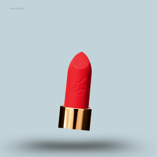 A close-up of the bright red bullet of Lisa Eldridge True Velvet Lip Colour Lipstick in a gold tube.