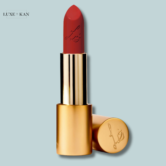 Close-up of a Luxuriously Lucent red lip colour tube with gold accents, featuring a lipstick bullet embossed with a logo.