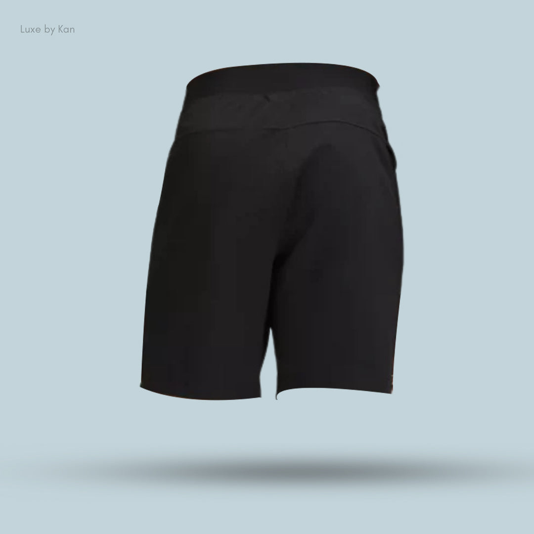 Black athletic shorts with a wide waistband, displayed against a light blue background. Front view showcases a sleek, minimalist design.