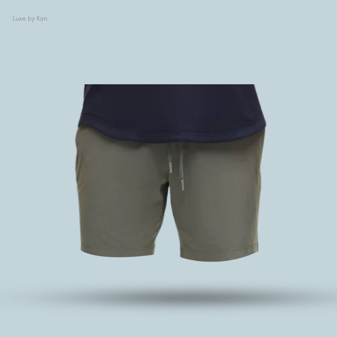 Men's casual outfit featuring navy blue top and olive green shorts with drawstring.