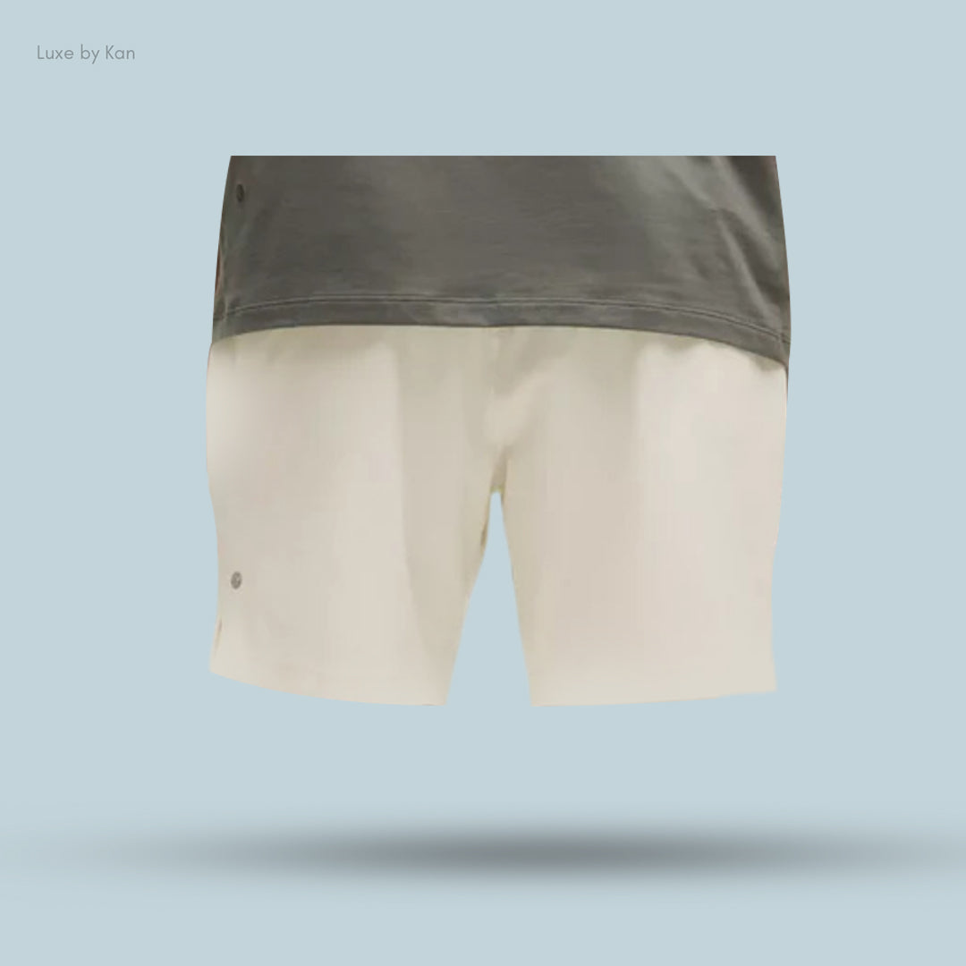 A grey short-sleeve shirt paired with cream-colored Lululemon Zeroed In Linerless Short 7".