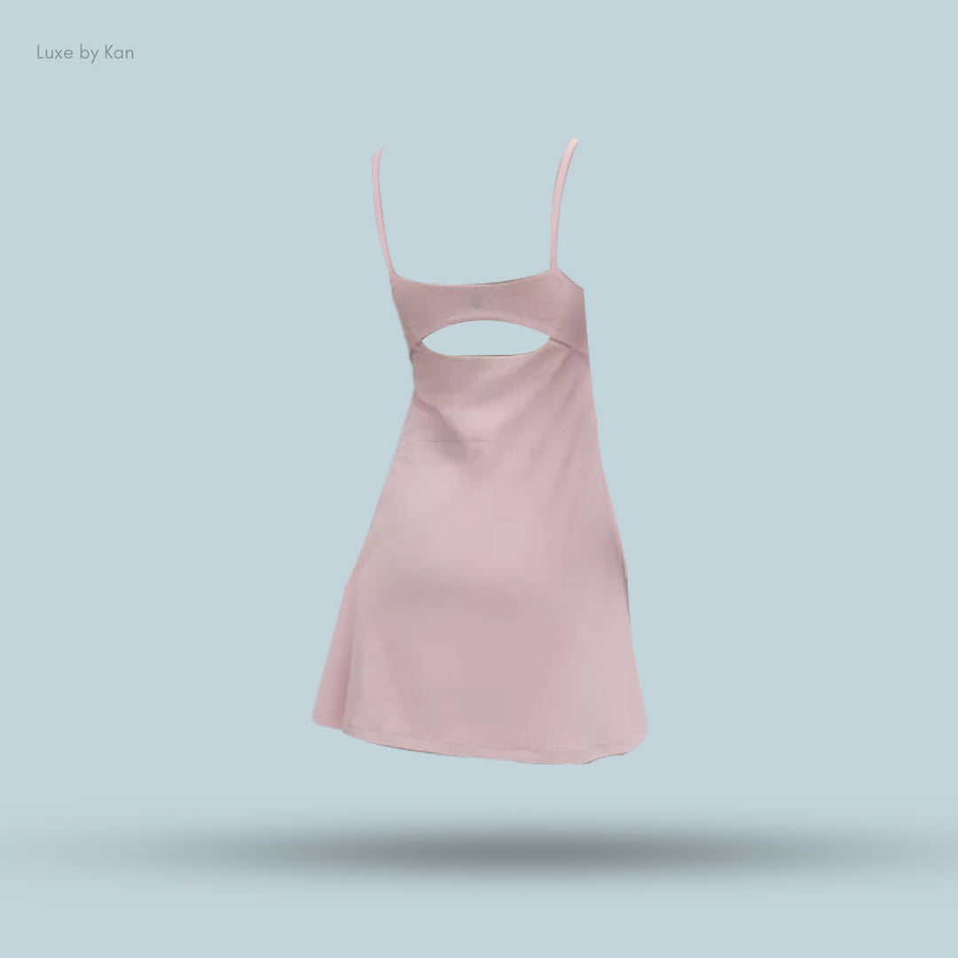 A light pink dress with a back cutout and thin straps. Ideal for casual spring outings.