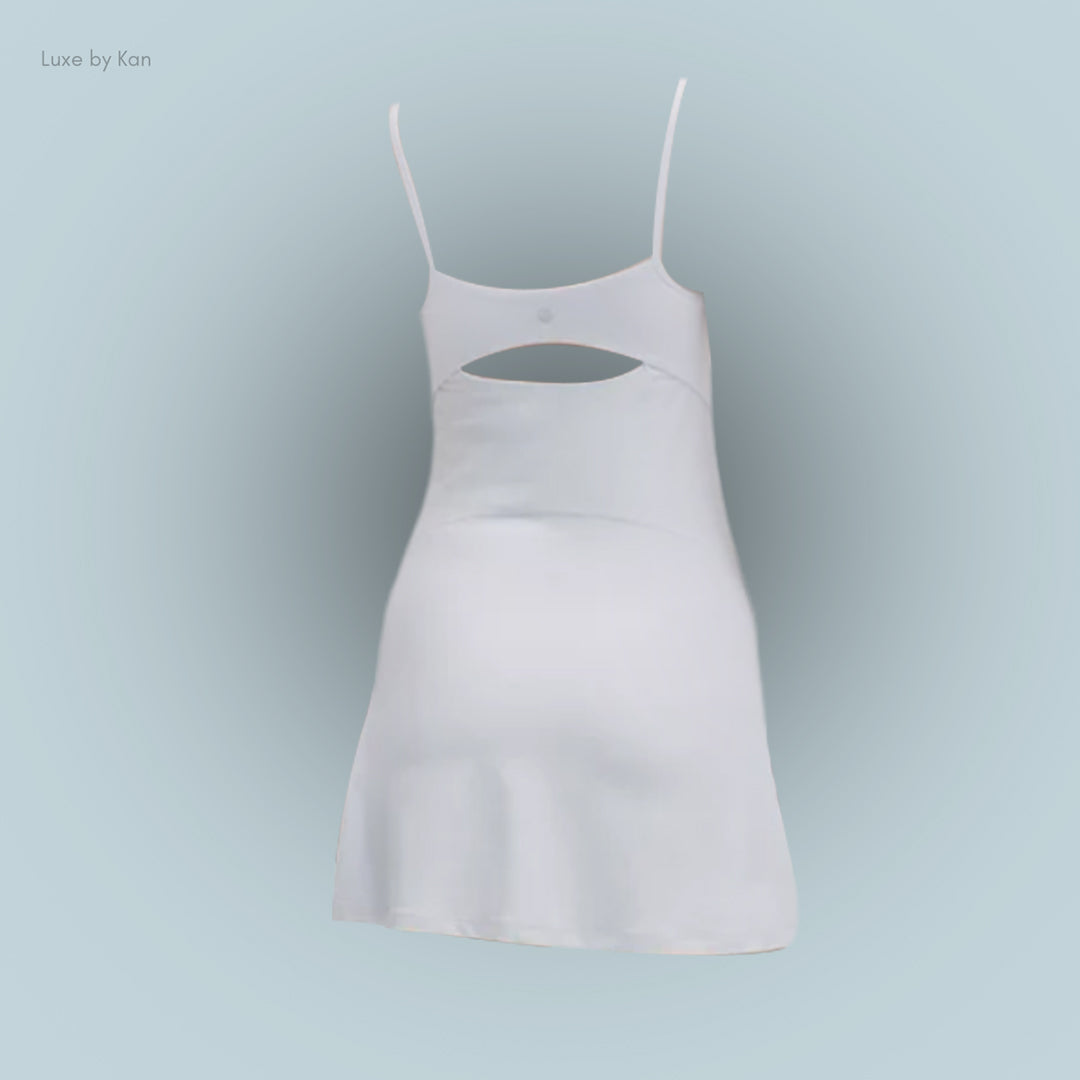 A minimalist white dress with thin straps, featuring a stylish cut-out on the back.