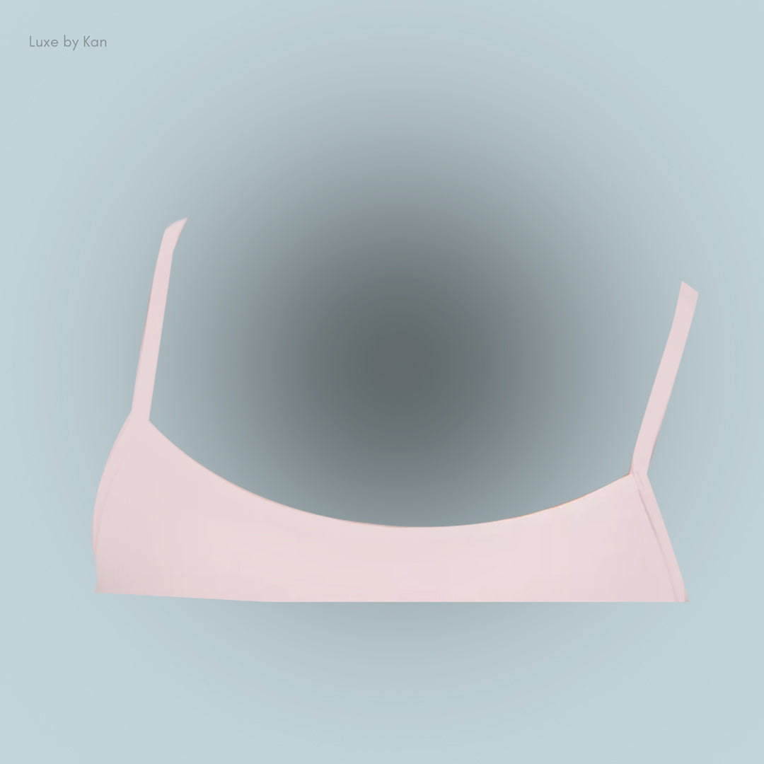 Light pink bralette with thin straps, showcasing a simple and elegant design.