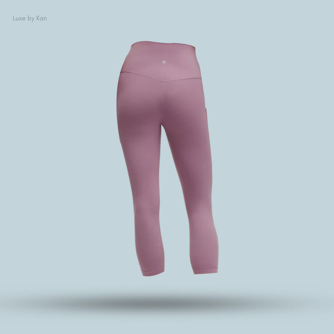 A pair of sleek, high-waisted pink leggings, showcasing their smooth fabric and design.