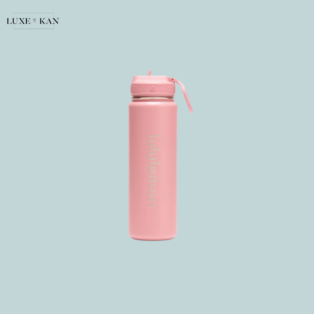 A sleek pink Lululemon ack to life sport water bottle with a lid and straw.