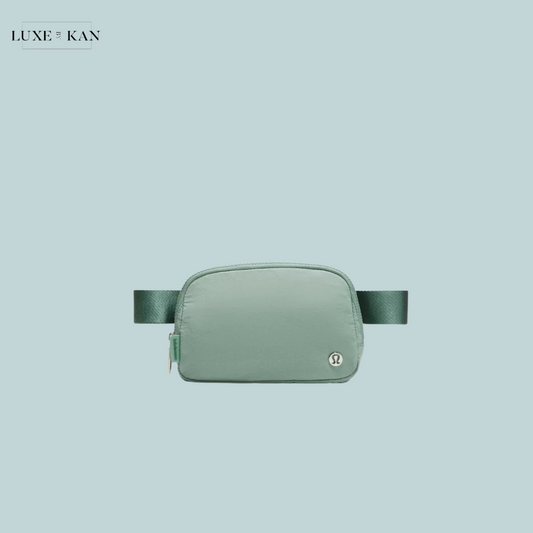 A mint green Lululemon Everywhere Belt Bag featuring a sleek design and a small logo.